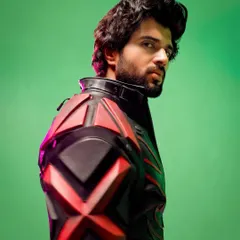 A powerful profile shot of Vijay Deverakonda in the custom Thums Up biker suit. The green screen background hints at the VFX to come, but the suit's strong silhouette already tells a story of action and power.