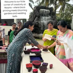 Welcome to our little corner of creativity at a Nesara wedding. Set against a backdrop of blooming gardens and a beautiful waterfall, our station became a hub where guests gathered to try their hand at block printing.