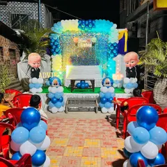 Here is a complete Boss Baby themed birthday stage I designed. The setup includes a shimmering sequin backdrop, character cutouts, and a blue and white balloon arch, perfect for a stylish first birthday party.