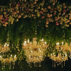 Transforming a daytime celebration into a magical evening is one of my favorite challenges. Here, we suspended dozens of crystal chandeliers from a canopy of lush greenery and pastel roses, creating an ethereal glow for a romantic cocktail party.