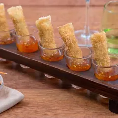 An elegant presentation of our crispy spring rolls, served individually with a sweet chili dipping sauce. This classic Asian appetizer is always a crowd-pleaser, showcasing our expertise in Pan-Asian cuisine.