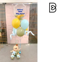 A cute and simple bouquet to welcome home Baby Jhaveri. This arrangement features a little baby sculpture holding a bunch of pastel balloons, including a clear bubble balloon with a personalized welcome message.