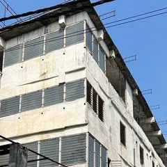 The original exterior of the building, showing its poor condition before we began the renovation and redesign process.