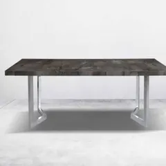 This dining table combines a dark, textured top with a sleek, chrome-finished metal base. The minimalist design is perfect for contemporary homes and apartments.