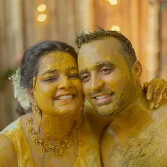 A happy, turmeric-covered couple posing for a photo after their Haldi ceremony in Goa. Their smiles are everything.