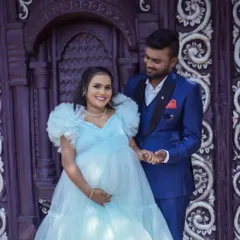 A close-up of a couple at the Santorini set. The ornate purple door adds a pop of color and texture, creating a sophisticated and stylish maternity portrait.