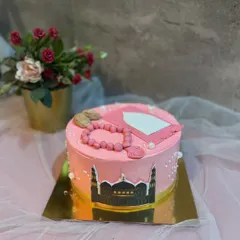 A pretty pink cake to celebrate a little girl's first Roza, decorated with a mosque silhouette and an edible prayer mat.