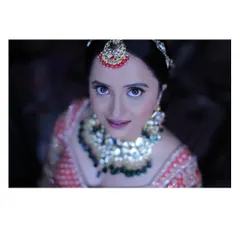 For this North Indian reception look, we went for full glam. I created a soft, shimmery pink eyeshadow look and sculpted her features to catch the light beautifully, making her eyes the star of the show.