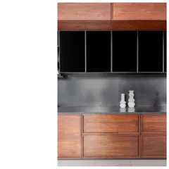 A detail of the kitchen cabinetry in the Bombay Penthouse. The contrast between the warm teak, the dark glass, and the cool granite backsplash is a study in material harmony.