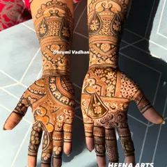 An elegant design for a guest, featuring traditional Indian motifs like the doli (palanquin) and elephants. It’s detailed without being as extensive as a full bridal design.