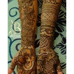 A design showcasing a prominent Ganesha figure on one hand, balanced with intricate floral and paisley patterns on the other for a unique, asymmetrical look.