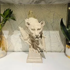 A beautiful lion cub sculpture, also in our signature stone-finished resin. This piece captures a sense of innocence and wild beauty.