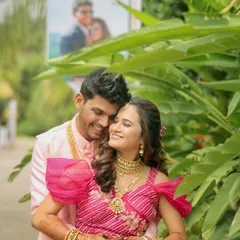 A happy couple portrait from a wedding event, framed by lush greenery, capturing a moment of warmth and affection.