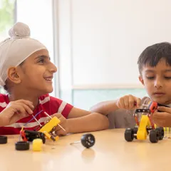 Friendship and teamwork are at the heart of our robotics classes. Here, Ishkabir and Ahaan collaborate on their project, learning that creating cool bots is even better when done together.