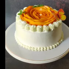 A smaller version of my mango rose cake, perfect for intimate celebrations. It has the same beautiful mango topping and is finished with a delicate piped buttercream border and a whimsical butterfly accent.
