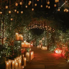Imagine walking into your celebration through a pathway of pure magic. We created this ethereal walkway with hundreds of candles in glass hurricanes and hanging lanterns, casting a warm, romantic glow that promises an evening of unforgettable moments.