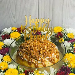 A birthday celebration featuring my Butterscotch Caramel Tres Leches. This cake has a moist sponge soaked in rich butterscotch caramel and is topped with a generous amount of crunchy almond praline.