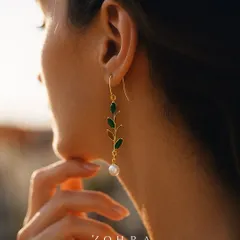 Jewellery should capture emotion. I designed these custom earrings with emerald leaves and a single pearl drop to feel like a cherished memory. Worn here, they catch the light beautifully, showing how a piece can become a natural extension of the person who wears it.