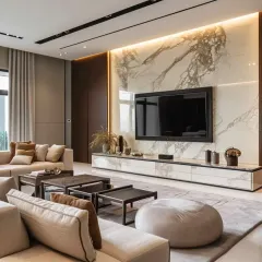 A stunning living room where the TV wall is the hero. I used a large slab of book-matched marble as the backdrop for the television, creating a powerful and luxurious statement piece.