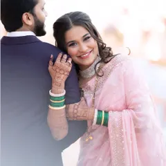 A sweet, romantic moment from their reception. Her makeup is soft and pretty in a pink saree, perfect for the evening's celebration.