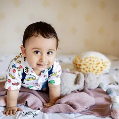 Hello, sweet child! This little boy gives a curious look as he crawls on the bed. Capturing babies in their own space, like the nursery, makes for comfortable and personal lifestyle baby photography.