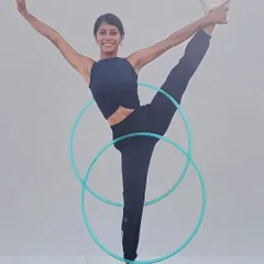 Squeezing in some doubles practice with my hula hoops while stretching. These track pants are perfect for moving freely, whether I'm doing yoga or hooping.