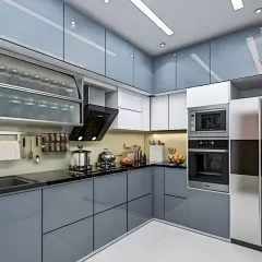 A sleek and functional L-shaped kitchen with glossy grey handleless cabinets. This design incorporates a tall unit for a built-in oven and microwave, frosted glass upper cabinets for lighter visual weight, and smart storage for spices and utensils.