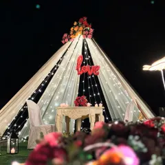 Another angle of the 'Love' proposal tent, showing the surrounding floral arrangements and lanterns that add to the romantic setting.