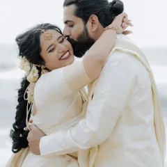 A heartfelt kiss on the forehead, a tender moment from a beautiful beachside wedding in Kerala. We focus on capturing these emotional connections.