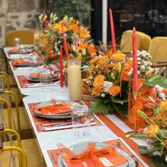 The full tablescape, showing how the colors, flowers, and candles come together to create a luxurious dining experience.