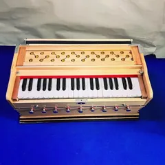 An overhead view of our 9-stopper harmonium, showing the keyboard and intricately designed jaali. This non-folding model is built for stability and excellent sound projection.