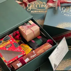 A look inside the Australian Consulate's Christmas hamper. It included a mix of Australian treats like Tim Tams and local festive items like plum cake and honey.
