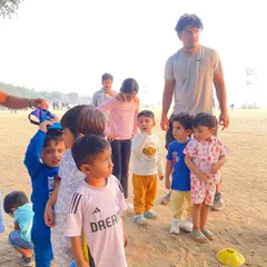 A group of toddlers listening intently to instructions. Even our youngest athletes are captivated by the fun and games we have planned on the beach.