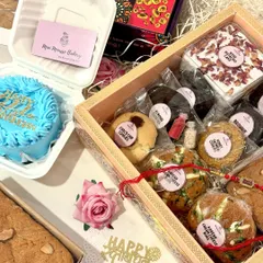 A complete Rakhi celebration in a box. This view shows how you can combine a larger hamper with a custom bento cake for an extra special touch. I love creating these personalized combinations for your celebrations.