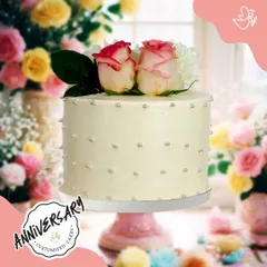 A chic and simple anniversary cake, topped with fresh roses and dotted with silver pearls. This minimalist design is both modern and timelessly romantic.