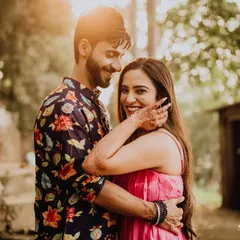 A sun-kissed pre-wedding portrait. The warm light and the couple's happy embrace make for a perfect, romantic memory.