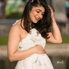 A joyful, candid shot of Aditi during her maternity session, with the wind in her hair, creating a feeling of freedom and happiness.