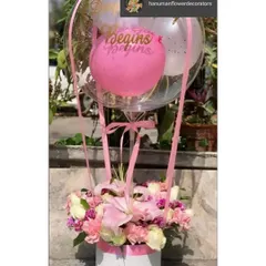 Perfect for a birthday, this arrangement features a box of fresh pink and white flowers, including lilies and carnations. It is topped with a large, personalized balloon to make the celebration extra special.
