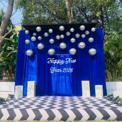 A fun selfie booth is a must for any modern party. For this New Year's event, I created a vibrant photo zone with a royal blue velvet backdrop, a custom sign, and dozens of sparkling disco balls.