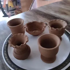 A collection of beautiful clay pots and vases handcrafted by children during our pottery workshop. Each piece is unique and showcases the child's individual creativity.