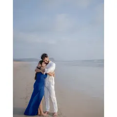 A quiet hug by the shoreline. The vastness of the sky and the sea makes for a simple yet powerful backdrop, putting all the focus on the couple's embrace during their beach pre-wedding shoot.