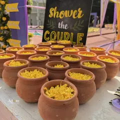 A creative and interactive detail for a Haldi ceremony. Guests were invited to 'shower the couple' with flower petals from these charming little mud pots, adding a rustic and personal touch to the celebration.