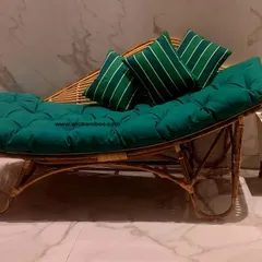 Unwind on our handcrafted rattan lounger, designed for ultimate relaxation. The ergonomic curve and plush, tufted green cushion provide excellent support, making it a perfect addition to a reading corner or sunroom.
