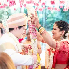 The joyful exchange of garlands during a cross-cultural wedding, a moment filled with laughter and happiness. I ensure that traditional rituals are celebrated beautifully, blending cultures seamlessly.