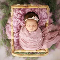 All wrapped up and so loved. I used a soft, textured wrap and a rustic basket to create this cozy little nest, surrounded by delicate lavender flowers for a touch of natural beauty.