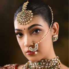 A powerful portrait of a North Indian bride. The focus is on her expressive eyes, enhanced with a classic winged liner and perfectly sculpted brows.