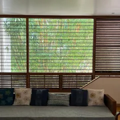 A view from our studio's living space, where a large window frames the dense bamboo foliage outside. This illustrates our principle of using landscape to create a sense of depth and a natural backdrop for interior spaces.