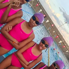 The girls showing off their team spirit and personality. We work hard in the pool, but we always make time for fun.