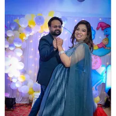 My rental gowns are not just for photoshoots. This client is glowing at her baby shower in a stunning, shimmery blue gown with an elegant cape. We also provided the suit for her partner, creating a polished look for their celebration.