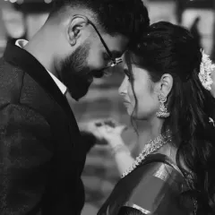 A dramatic and intimate black and white portrait of the couple. This artistic shot focuses on their connection and the emotion of the moment, creating a timeless image.